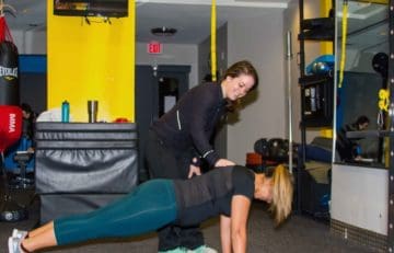 Trainer with client Plank